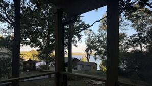 A covered porch with a view of a lake and houses in the background. - Water view 3-bedroom house in Camden with AC and WiFi walking distance to lake (Camden)