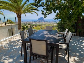 Enjoy al fresco dining in an outdoor space with a city view.