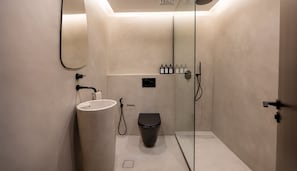 A modern bathroom with a sink, toilet, and shower. - Sky Gardens - Mint Stay (Dubai)