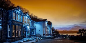 A historic building with a stone facade, large windows, and a prominent entrance. - Craigside Manor (Llandudno)