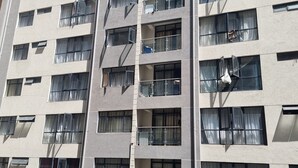 A multi-story building with numerous windows, some with curtains. - Serenity Escape in Nairobi City (Nairobi)