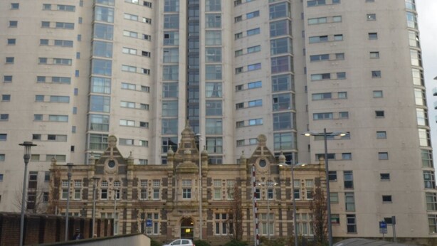 A tall, modern apartment building with a central tower and multiple balconies. - Bute Terrace Apartment - Cardiff City Center (Cardiff)