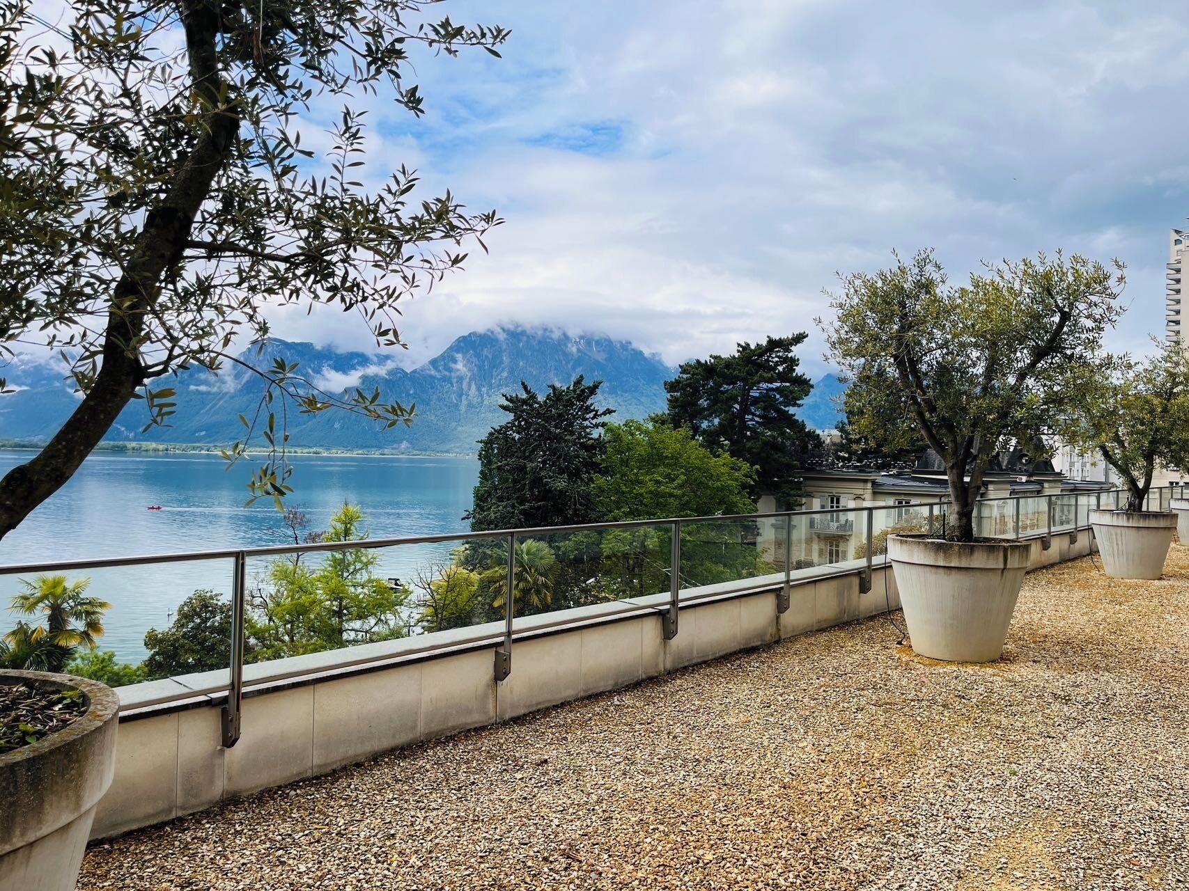 A balcony with a view of a lake and mountains.