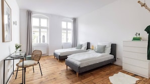 A modern bedroom with two single beds, a wooden floor, a desk with a chair, and a large window. - 75sqm flat 1st occupancy, near centre & PrenzlBerg (Berlin)