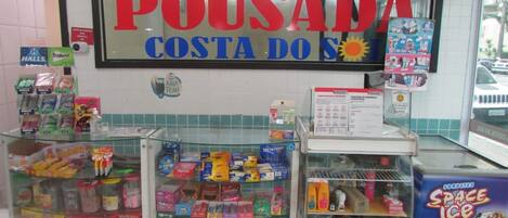 A store with a large sign reading "POUSADA COSTA DO S".