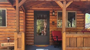 A wooden cabin with a front porch, a door, and a welcome sign. - Rancho Relaxo, large fully fenced pet friendly lot. Centrally located (Big Bear)