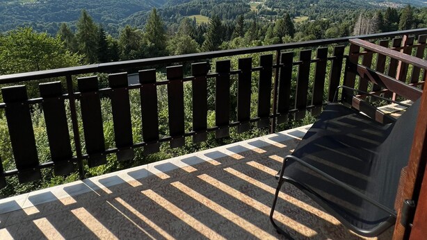 Un balcon donnant sur un paysage montagneux.