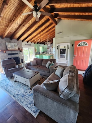 A cozy living room with a fireplace, a sectional sofa, and a coffee table.