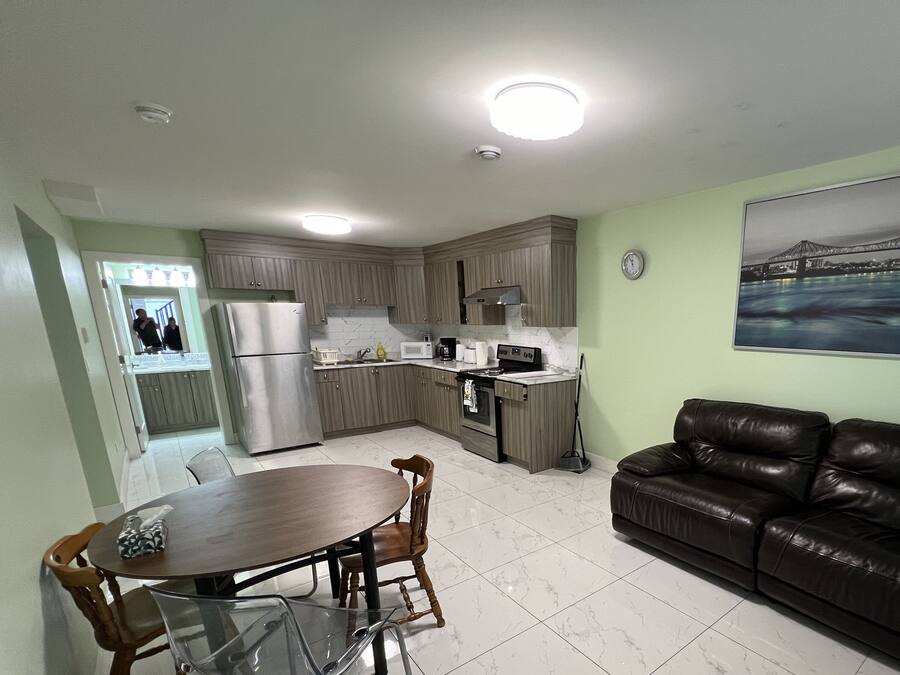 A compact living space with a kitchenette, dining area, and a sofa.