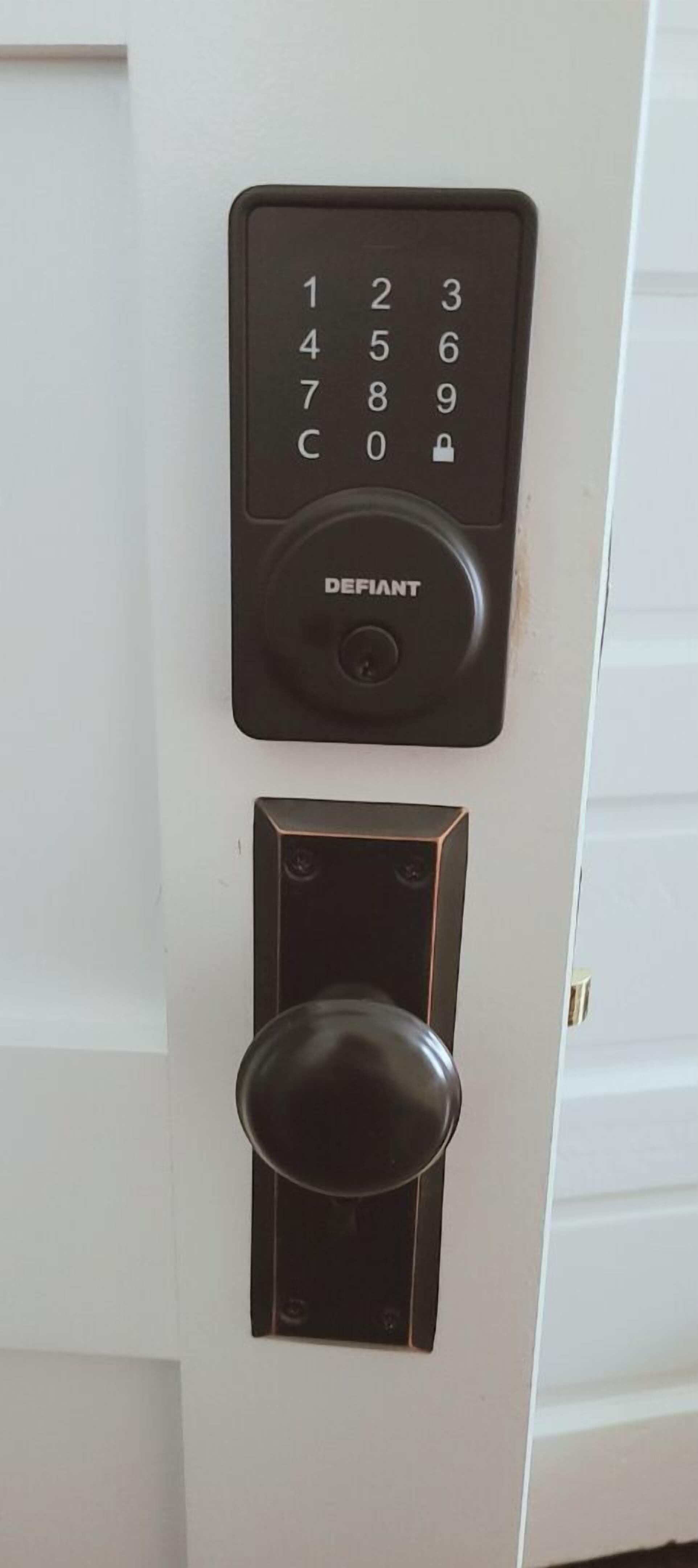 A door with a numeric keypad and a keyhole lock.
