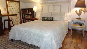 A bedroom with a large bed, a bookshelf, a lamp, and a decorative rooster. - Vogelsang guesthouse, 5 minute walk to downtown West Jefferson. (West Jefferson)
