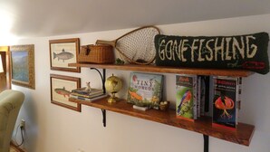 A bookshelf with books, a globe, and a fishing net.