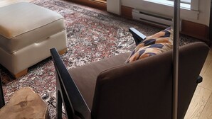 A spacious room with large windows, a floor lamp, a sofa, and a rug. - Mariner's Loft Salt Spring Island - 2BDRM - Unit 201 (Salt Spring Island)