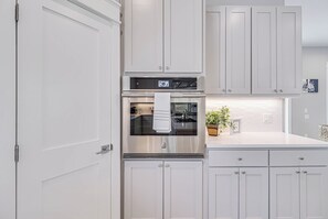 Enjoy cooking in this well-equipped kitchen with a refrigerator, oven, and ample counter space.