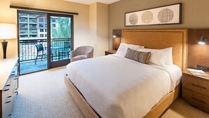 A hotel room with a large bed, a chair, a desk, and a balcony with chairs. - Spacious 2-Bedroom Suite w/ King & 2 Queens, Views (Park City)