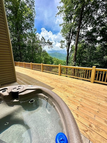Relax in the hot tub on the deck overlooking the mountains.