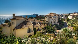 A coastal residential area with terracotta-roofed buildings, a clear blue sky, and a view of the sea. - 'Gadea 11-2' Apartment with Sea Views, Wi-Fi, and Air Conditioning (Altea)