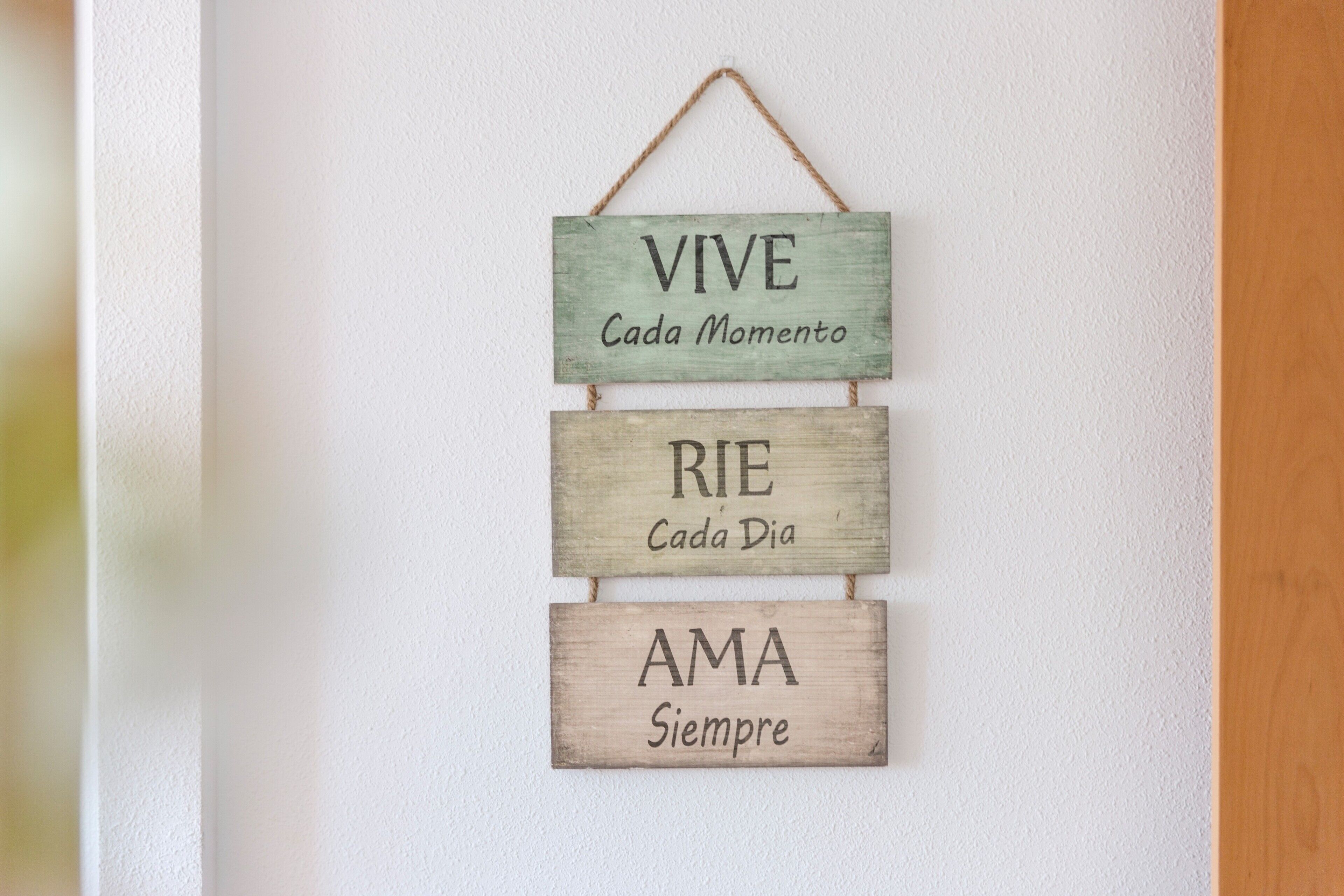 A wooden sign with motivational phrases.