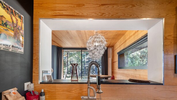 A modern kitchen with a stainless steel sink, wooden cabinetry, and a large window offering a view of trees. - Modern Family Chalet with Mountain View, Private Terrace and Wi-Fi (Bolquère)