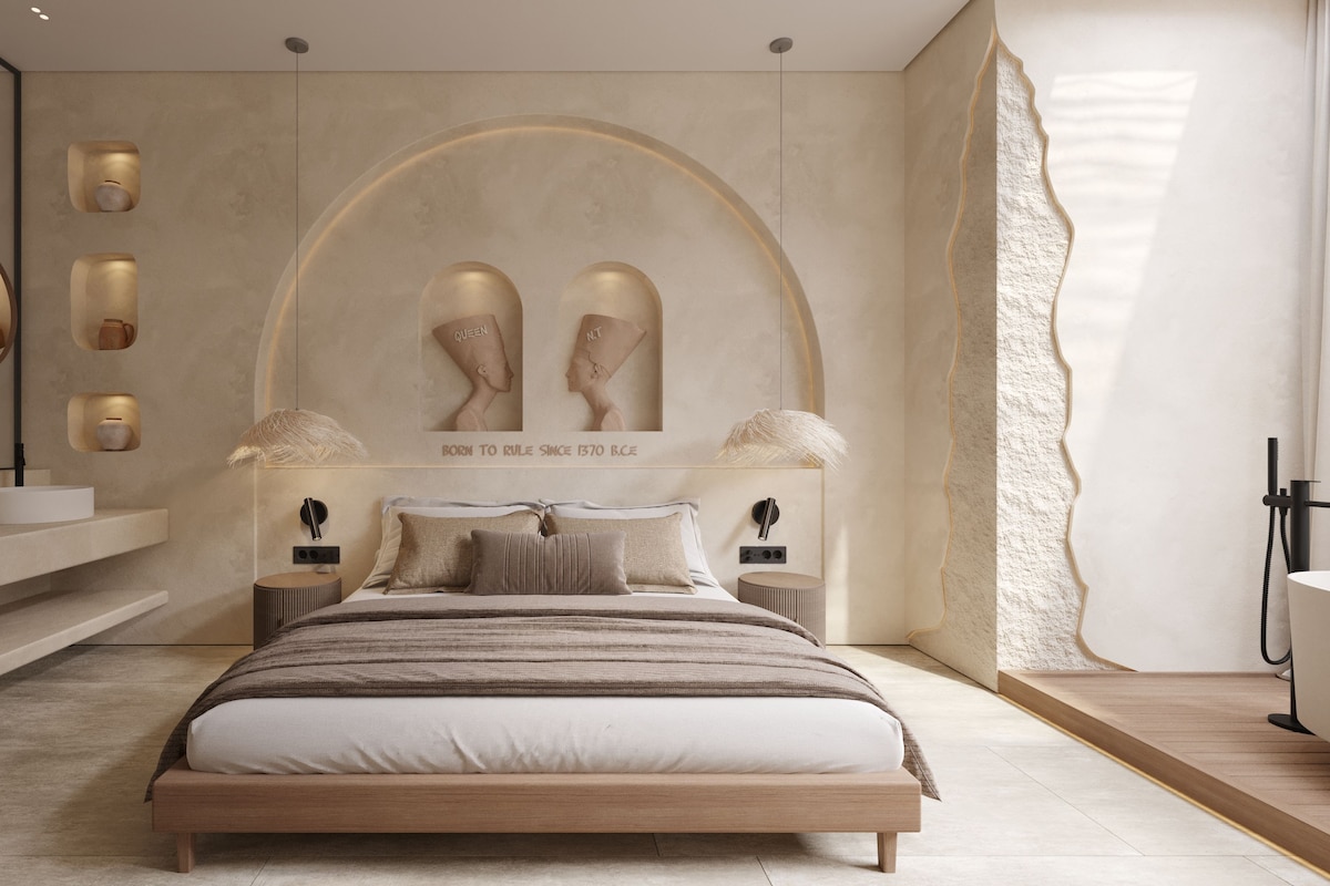 Un dormitorio moderno con una cama grande, un tocador con espejo y un diseño de cabecera único.
