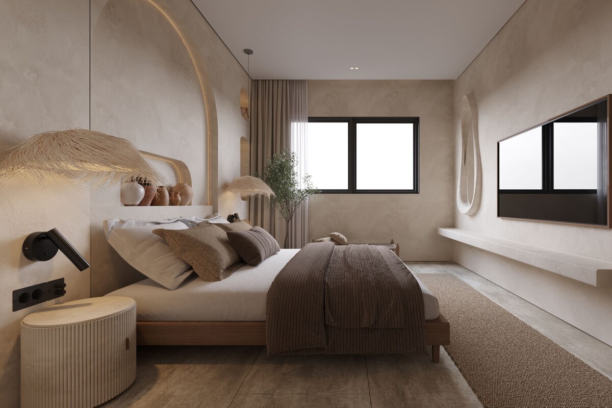 Un dormitorio moderno con cama, mesitas de noche, televisor montado en la pared y un ventanal grande.