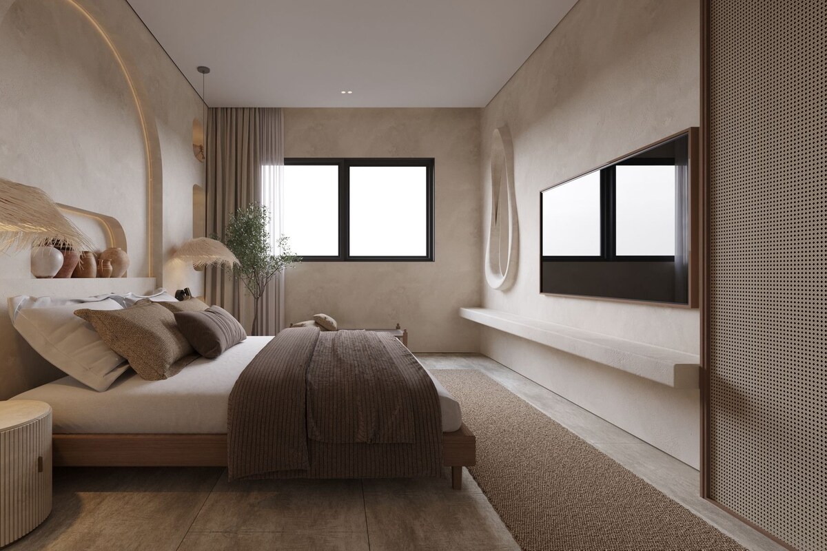 Un dormitorio moderno con una cama grande, lámparas de noche, un televisor y una ventana.