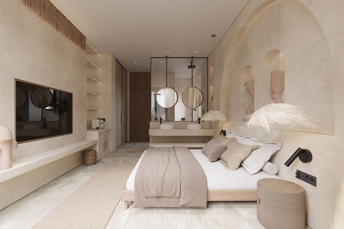 Een moderne slaapkamer met een groot bed, een televisie, een kaptafel met spiegels en een groot raam.