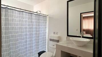 Shower, hair dryer, towels, toilet paper