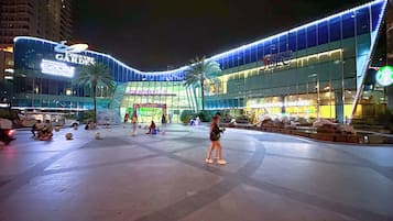 A large, modern building with a curved facade, a prominent sign for 'Country Garden', and a Starbucks coffee shop on the ground floor.