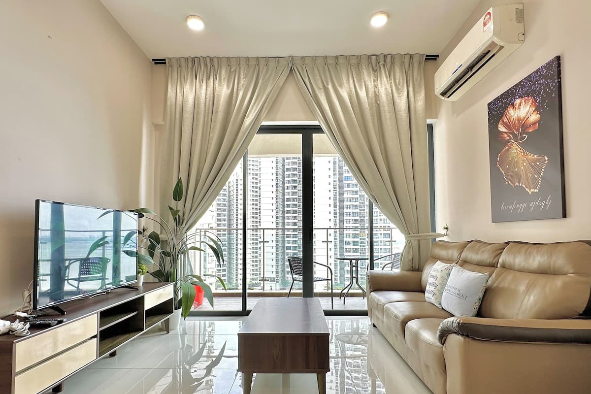 A modern living room with a leather sofa, a TV, and a dining table.