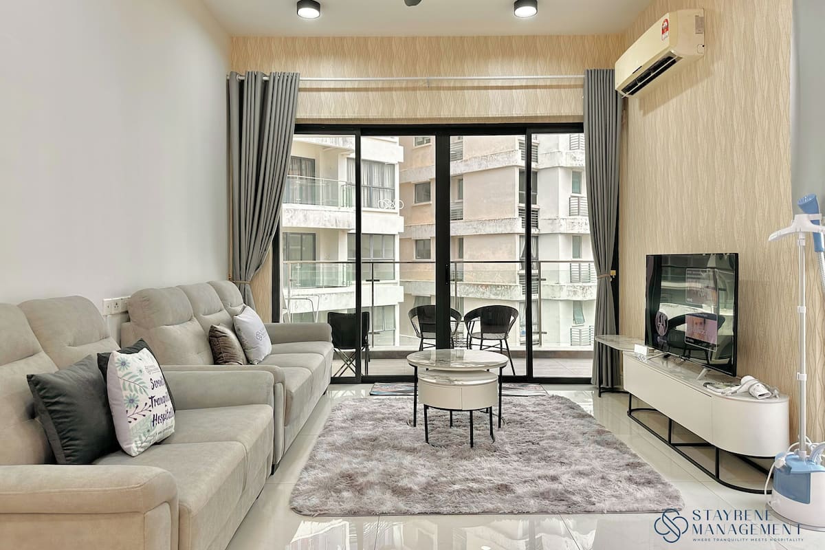 A modern living room with a sofa, a coffee table, and a TV.