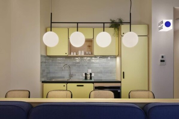 A compact kitchen with a central island, a sink, and a countertop.