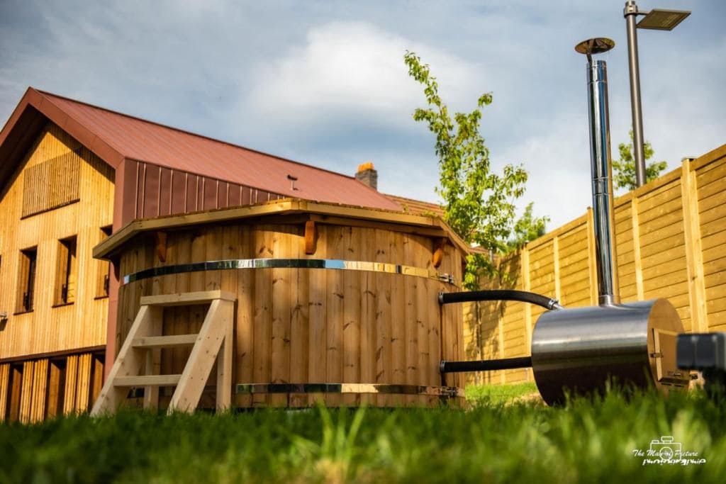 A wooden structure with a red roof, a metal grill, and a solar panel.