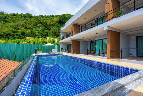 Une maison moderne à deux étages avec une piscine.