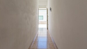A narrow hallway with tiled flooring leading to a door. - 4061 Casa Wilma by Barbarhouse (Porto Cesareo)