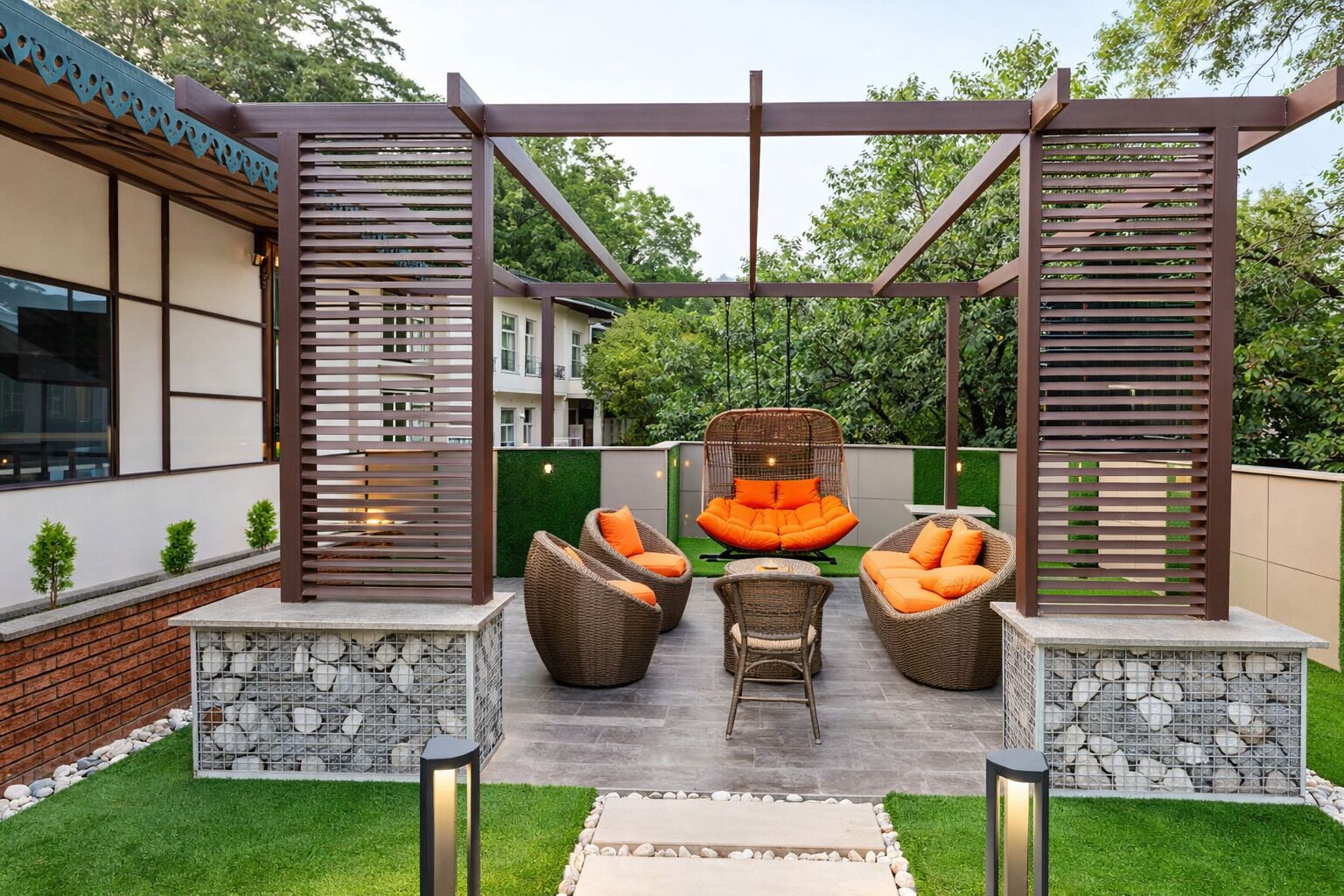 An outdoor seating area with wicker furniture and a hanging chair, surrounded by a wooden pergola structure.