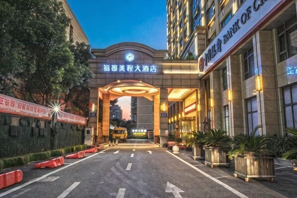 A hotel entrance with a large archway, a sign for the Bank of China, and a well-lit facade. - Fujun Meicheng Hotel (Suzhou)
