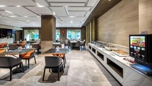 A modern dining area with tables and chairs, a buffet counter, and a digital menu display. - Fujun Meicheng Hotel (Suzhou)