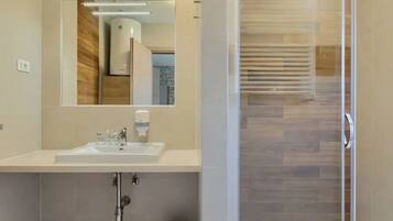 Shower, hair dryer, towels, toilet paper