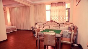 Una habitación con una mesa de billar verde, un sofá y una cama.