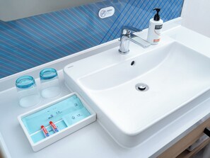 A bathroom with a white sink, a soap dispenser, and a digital scale. - Holiday Inn Express Zhengzhou Nongye Road by IHG (Zhengzhou)