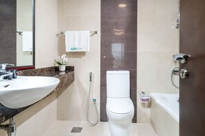 A bathroom with a white sink, toilet, and bathtub.