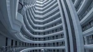 A multi-level building with curved balconies and a central atrium.