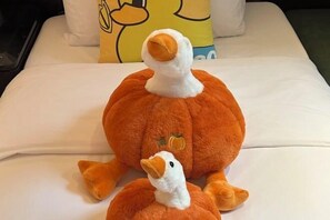 A bed with two plush ducks and a pillow with a cartoon duck design. - Citigo Hotel Shanghai Jinqiao Jiayou (Shanghai)
