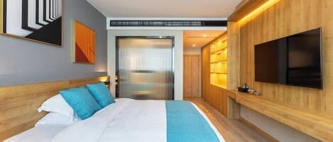 A modern hotel room with a large bed, a TV mounted on the wall, and a wooden panel design.