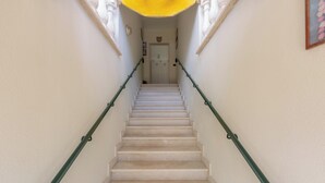 A staircase with white steps and green handrails, leading to a door at the top. - 4038 Bliss Attico Fronte Mare by Barbarhouse (Porto Cesareo)
