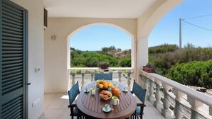 A balcony with a table set for breakfast, overlooking a scenic landscape. - 4038 Bliss Attico Fronte Mare by Barbarhouse (Porto Cesareo)