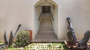 A staircase leading to an upper level, flanked by decorative anchors and a potted plant. - 4038 Bliss Attico Fronte Mare by Barbarhouse (Porto Cesareo)