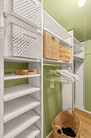 A storage area with shelves, baskets, and hanging clothes racks. - Dorado Golf Villa,Pet Friendly (Tucson)