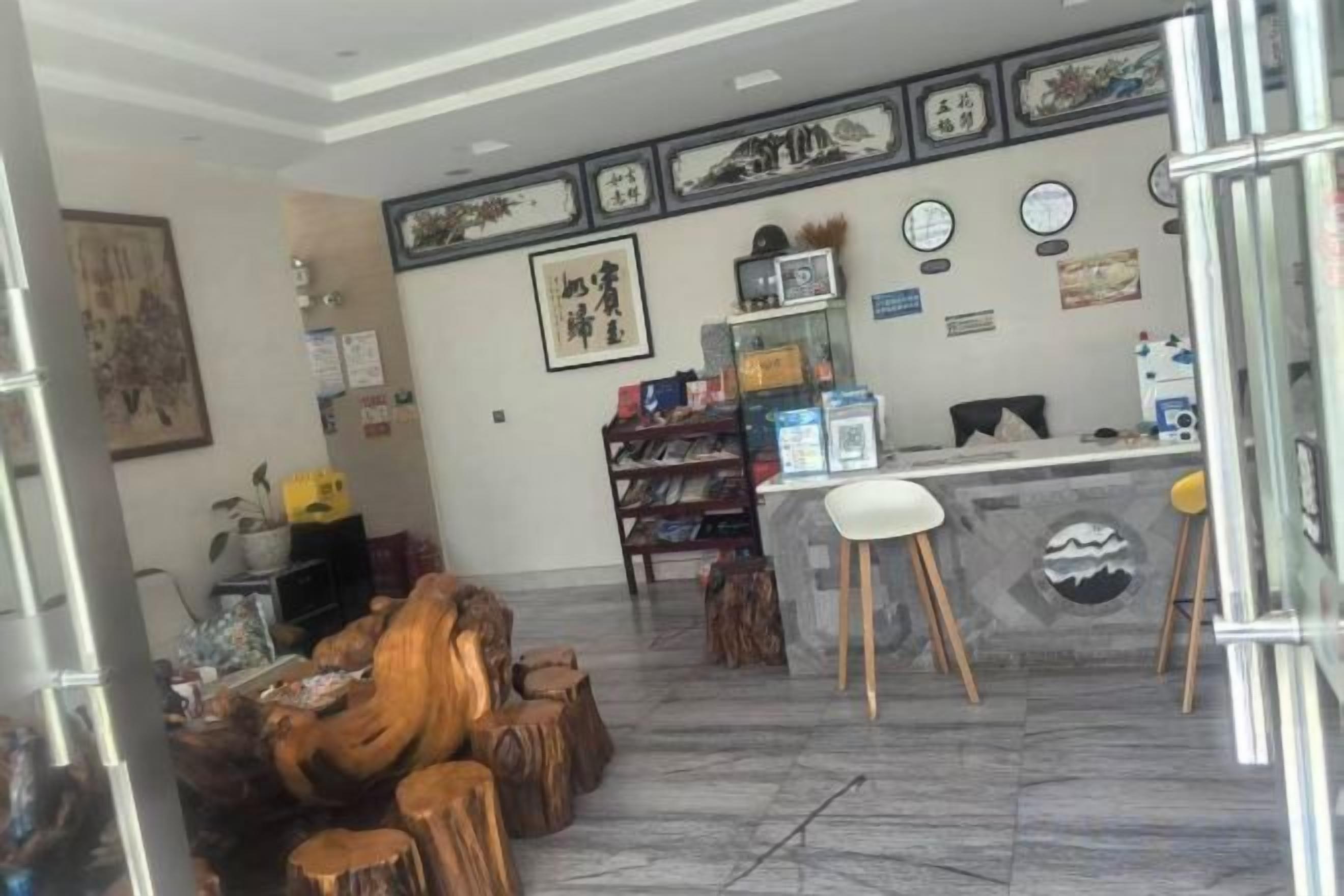 A reception area with a counter, chairs, and a display of items on shelves.